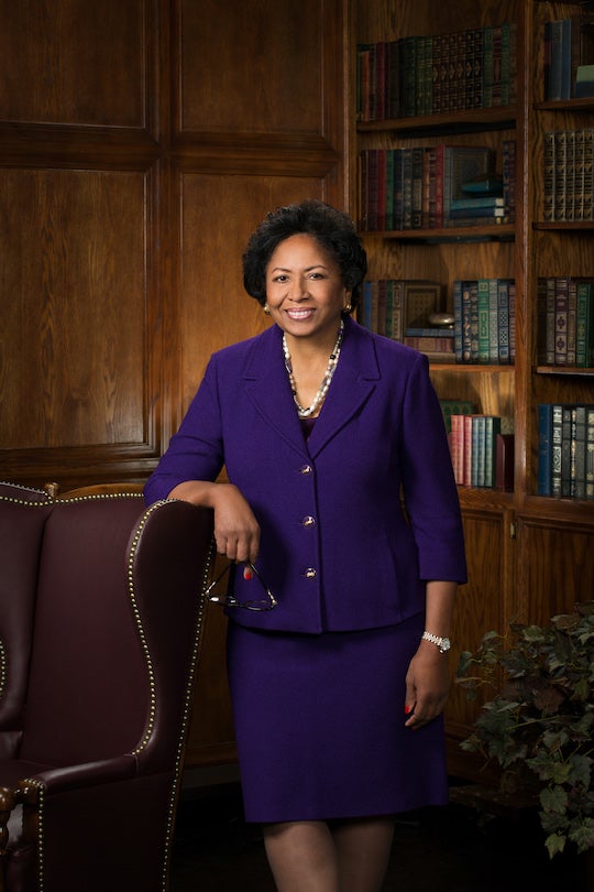 Ruth Simmons poses for a photo next to a chair.