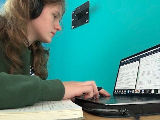 Ava Cheponis works on her research examining what motivates adolescent girls to participate in team sports during her summer at the University of Limerick in Ireland. (Photo courtesy of Ava Cheponis)