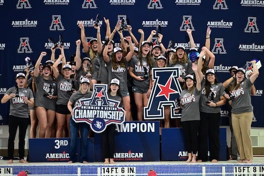 The Rice women's swimming and diving team celebrates after winning the 2025 AAC Championship.