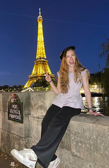 Karlianna Kapche pictured in front of the Eiffel Tower at night