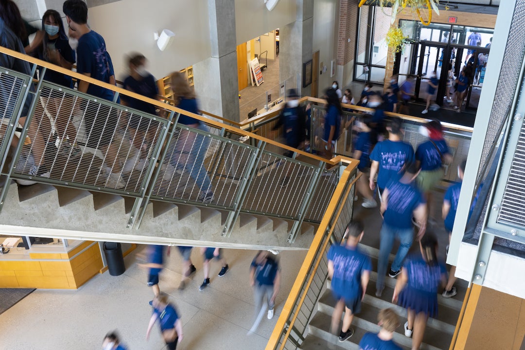 New Rice students climbing stairs in recreation center heading to academic fair