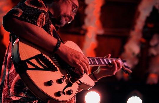 Aurun Son playing guitar at Dan Electro's