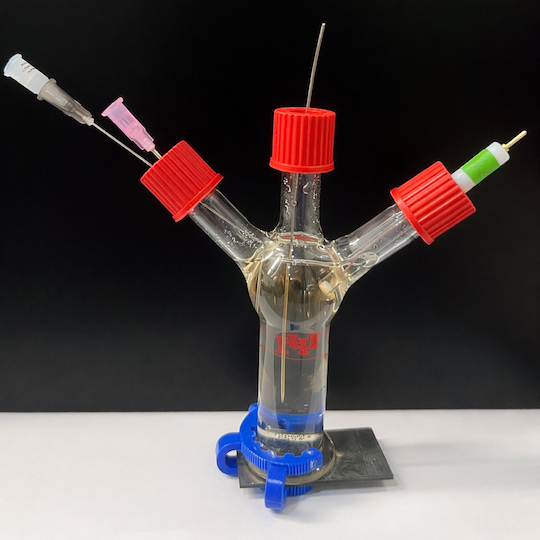 A clear tube with three columns, all capped in red, coming out of the top.