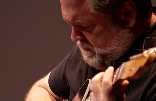 Chapman Welch playing guitar