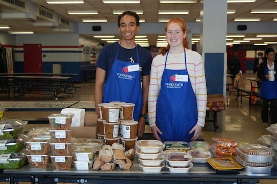 Rice University seniors Ian Wright and Anna Delesalle volunteer at a Second Servings pop-up at Paul Revere Middle School as part of their Social Policy Analysis capstone project.