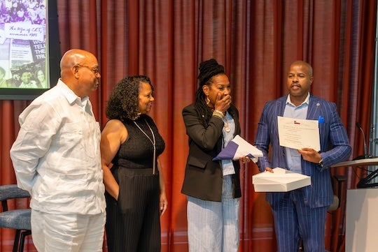 State Rep. Ron Reynolds, right, presents Kimberlé Crenshaw with a Texas flag that had flown over the state Capitol during her Sept. 14 visit to Rice University. Crenshaw was recognized for her influential scholarship on race, gender and the law.