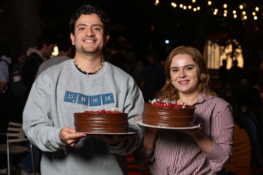 Graduate students pose with their cakes at Take the Cake, an annual celebration during which the dean of graduates and postdoctoral studies presents one cake for every major external fellowship received. Photo by Gustavo Raskosky