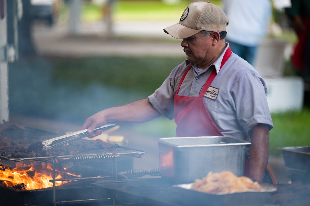 Goode Company worker grills meat at president's barbecue