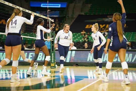 Rice volleyball player Carly Graham exults while surrounded by teammates on the court during the Owls' victory over Colorado in the first round of the NCAA Tournament.