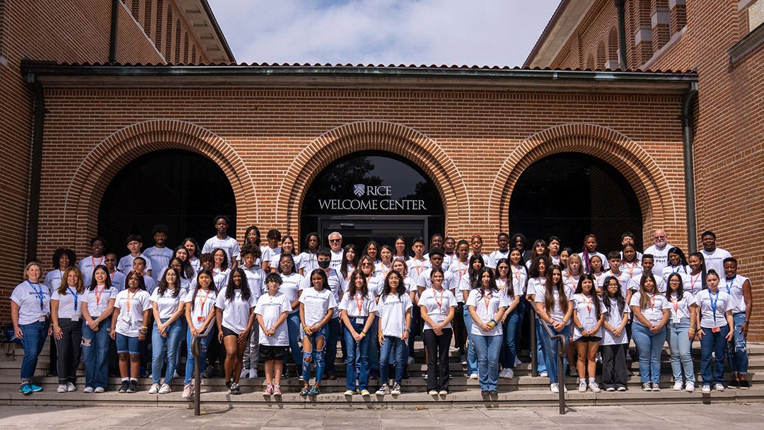 High school students pose with teachers and other sponsors at the Texas Diversity Council Summer Youth Program in front of the Rice Welcome Center on the Rice University campus.