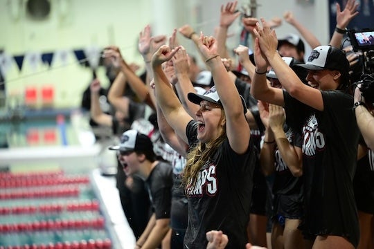 The Rice women's swimming and diving team celebrates after winning the 2025 AAC Championship.
