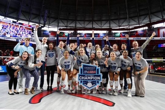 Players and coaches from the Rice volleyball team celebrate after winning the Conference USA tournament Nov. 20.