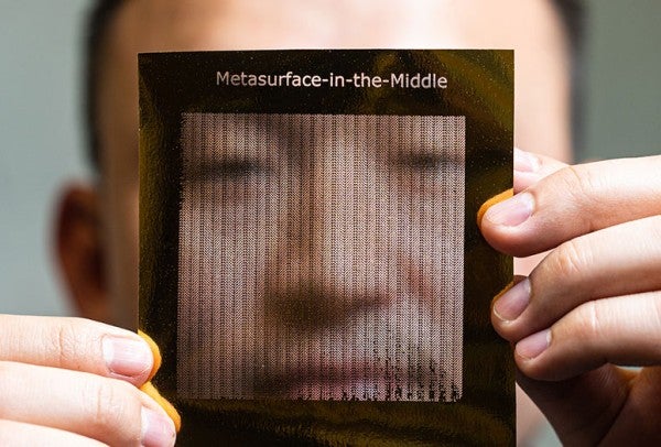 Zhambyl Shaikhanov holds a foil sheet used to create a metasurface for eavesdropping on 6G wireless signals