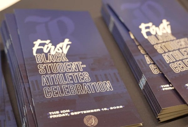 Programs for Rice's First Black Student-Athletes Celebration are pictured sitting on a table.