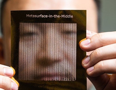 Zhambyl Shaikhanov holds a foil sheet used to create a metasurface for eavesdropping on 6G wireless signals