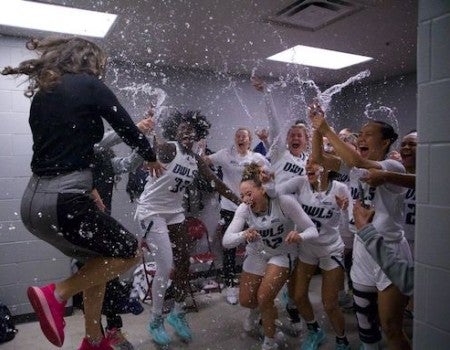 Rice women's basketball coach Lindsay Edmonds and the Owls celebrate after beating Texas A&M on Nov. 27, 2022. 