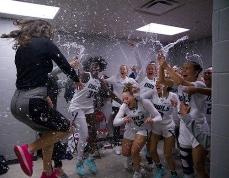 Rice women's basketball coach Lindsay Edmonds and the Owls celebrate after beating Texas A&M on Nov. 27, 2022.