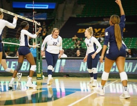 Rice volleyball player Carly Graham exults while surrounded by teammates on the court during the Owls' victory over Colorado in the first round of the NCAA Tournament Thursday in Waco, Texas.