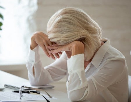 Photo of depressed working woman.