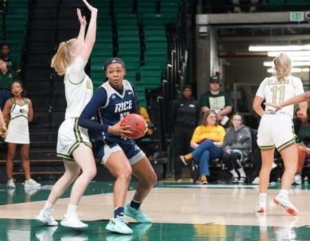 A Rice women's basketball player looks to shoot during a conference game against the University of Alabama at Birmingham.
