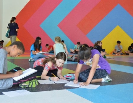 Students hone their writing skills at a past Creative Writing Camp at the Glasscock School of Continuing Studies.