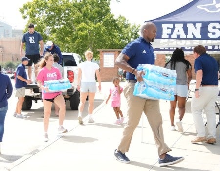 Rice student-athletes and staff load donations at the Brian Patterson Sports Performance Center as part of a two-day flood relief drive supporting Central Texas communities.