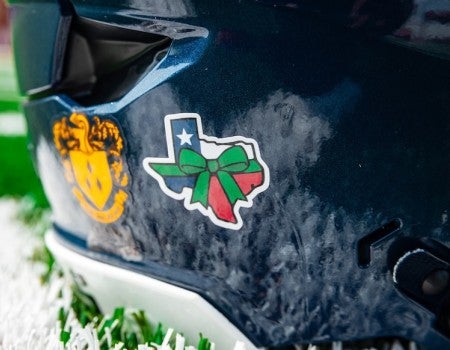Green ribbon helmet sticker in honor of Texas flooding victims 2025.