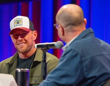 Roger Bennett interviews JJ Watt during a Men in Blazers live podcast at Rice University.