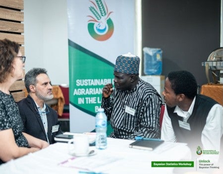 Frederi Viens talking with other researchers