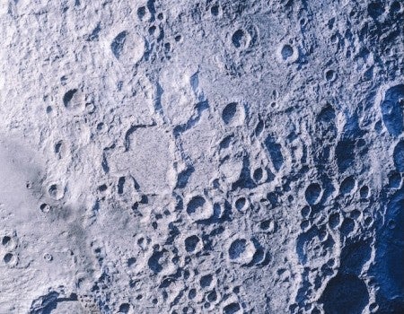 a close up of the moon's surface, which has many craters in it. 