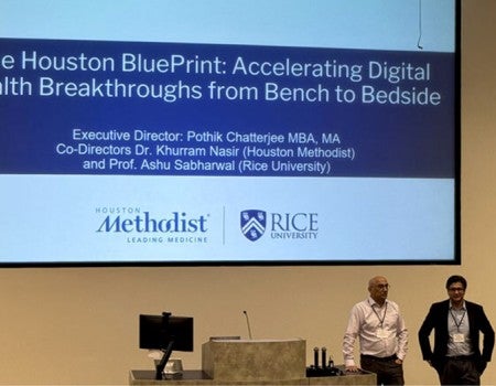 photo from event with lead organizers near a podium