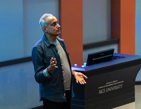 Man facing off to the side near a podium