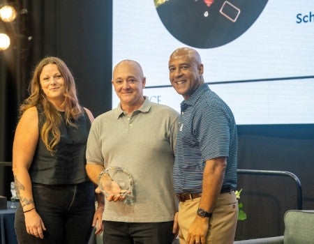 Brian Gibson receives the Gillis Award from Jessica Keithan and President Reginald DesRoches.