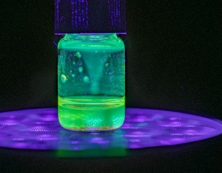 a jar with a glowing green liquid inside