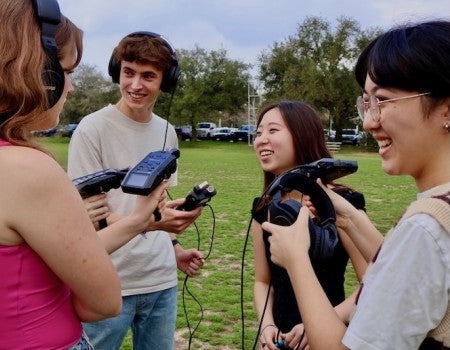 Students from the Houston Newsroom test out their new equipment.