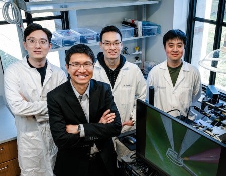 Yong Lin Kong and members of his team standing in his lab