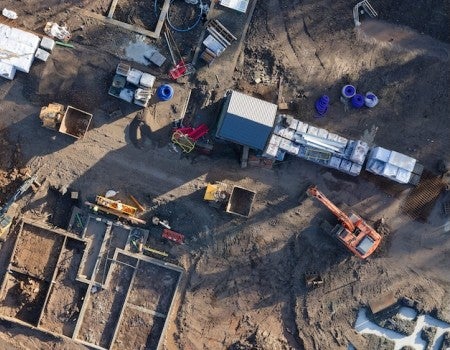 Stock image depicting aerial view of a construction site. 