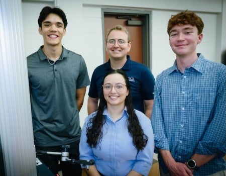 The group of researchers poses for a picture in the lab. 
