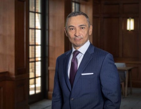 Peter Rodriguez standing in a blue suit