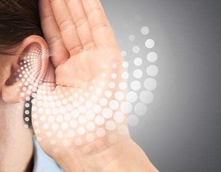 stock photo depicting person holding their hand to their ear