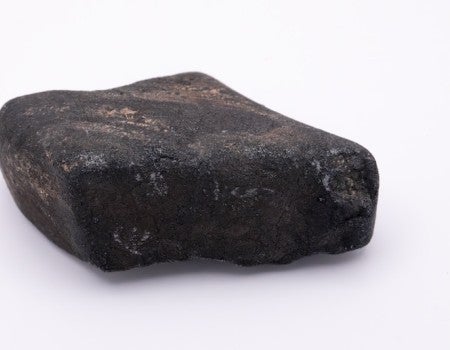 A black rock against a white background