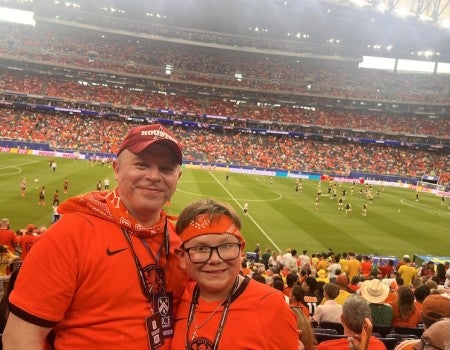 Mauricio Benitez (left) with his grandson Hiram at the Netherlands vs. Sweden match this year.