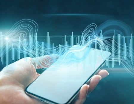 Sound waves over hand holding a smartphone