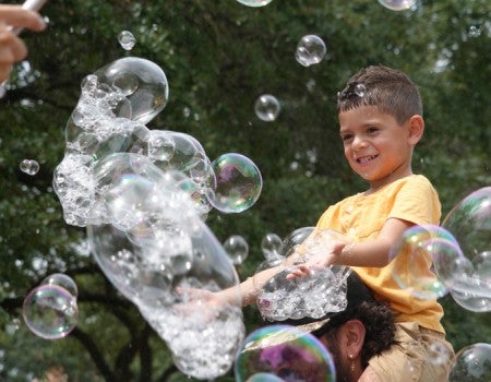 Boy hunting bubbles at the Moody Center for the Arts' Summer Jam 2026