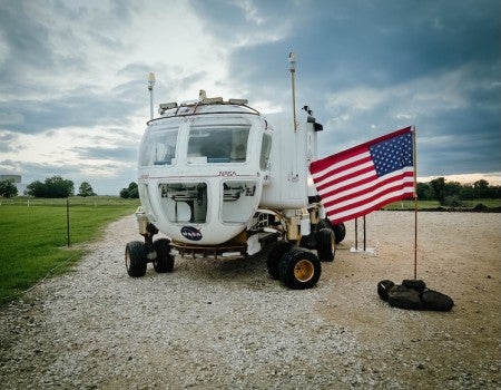 A picture of a pressurized rover at NASA’s Johnson Space Center. Team OWL SUITS was assigned to develop a pressurized rover interface for a simulated lunar mission scenario (Credit: Israel Cantu).  