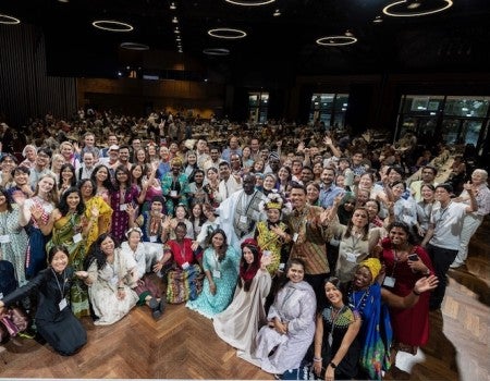 A large group of people dressed in various culture's traditional outfits