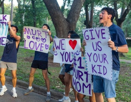 Rice students hold signs to welcome new classmates