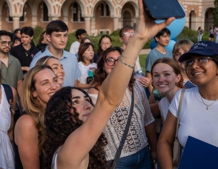 New masters students taking a selfie at Rice University.