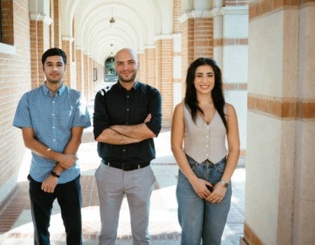 Farshid Alambeigi, center, with graduate students Daniyal Maroufi (left) and Mobina Tavangarifard (right). 