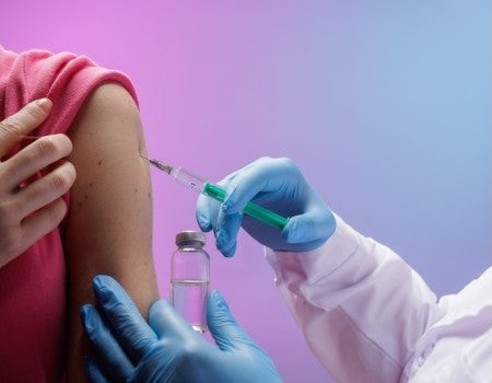 Vaccination in healthcare setting with injection. 